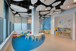 Interior Children's room, Abstract ceiling lighting, toy cubbies, book shelves, childrens table.